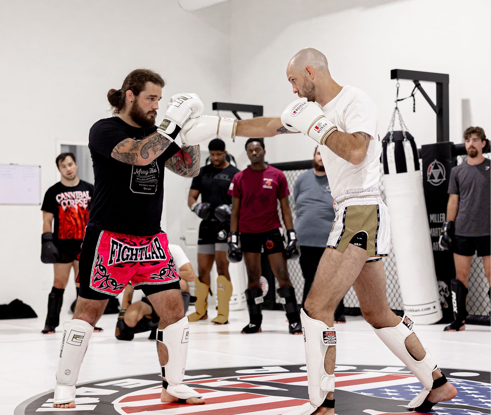 Coaches working pads at Miller Martial Arts